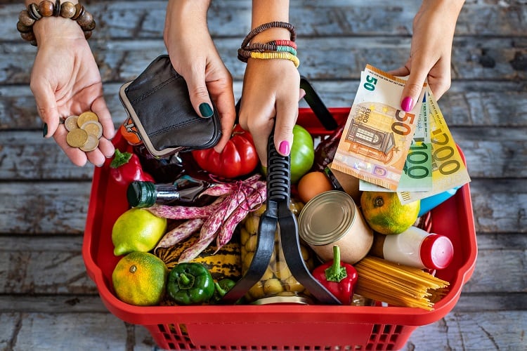 Supermarket basket with vegetables and fruits.