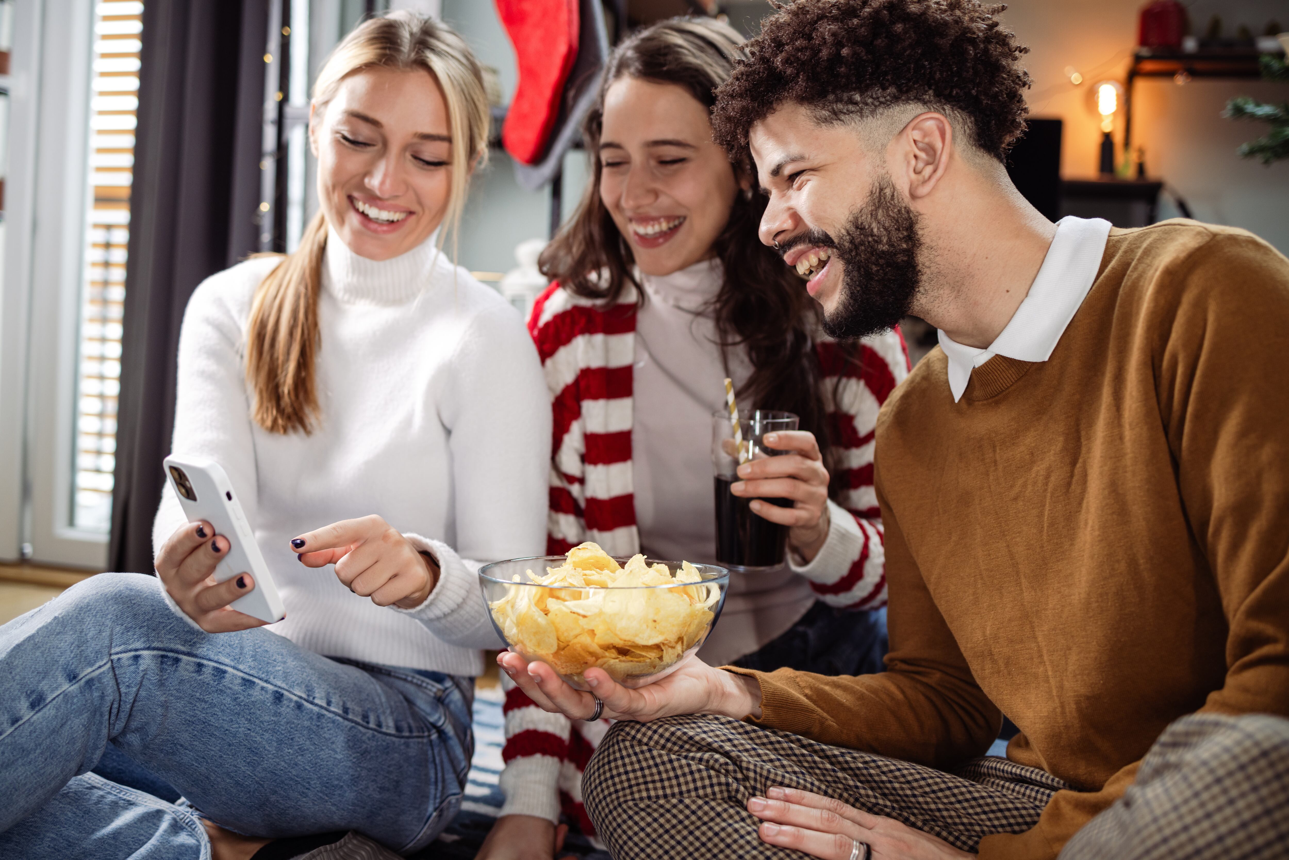Friends hanging out, eating snacks and on social media