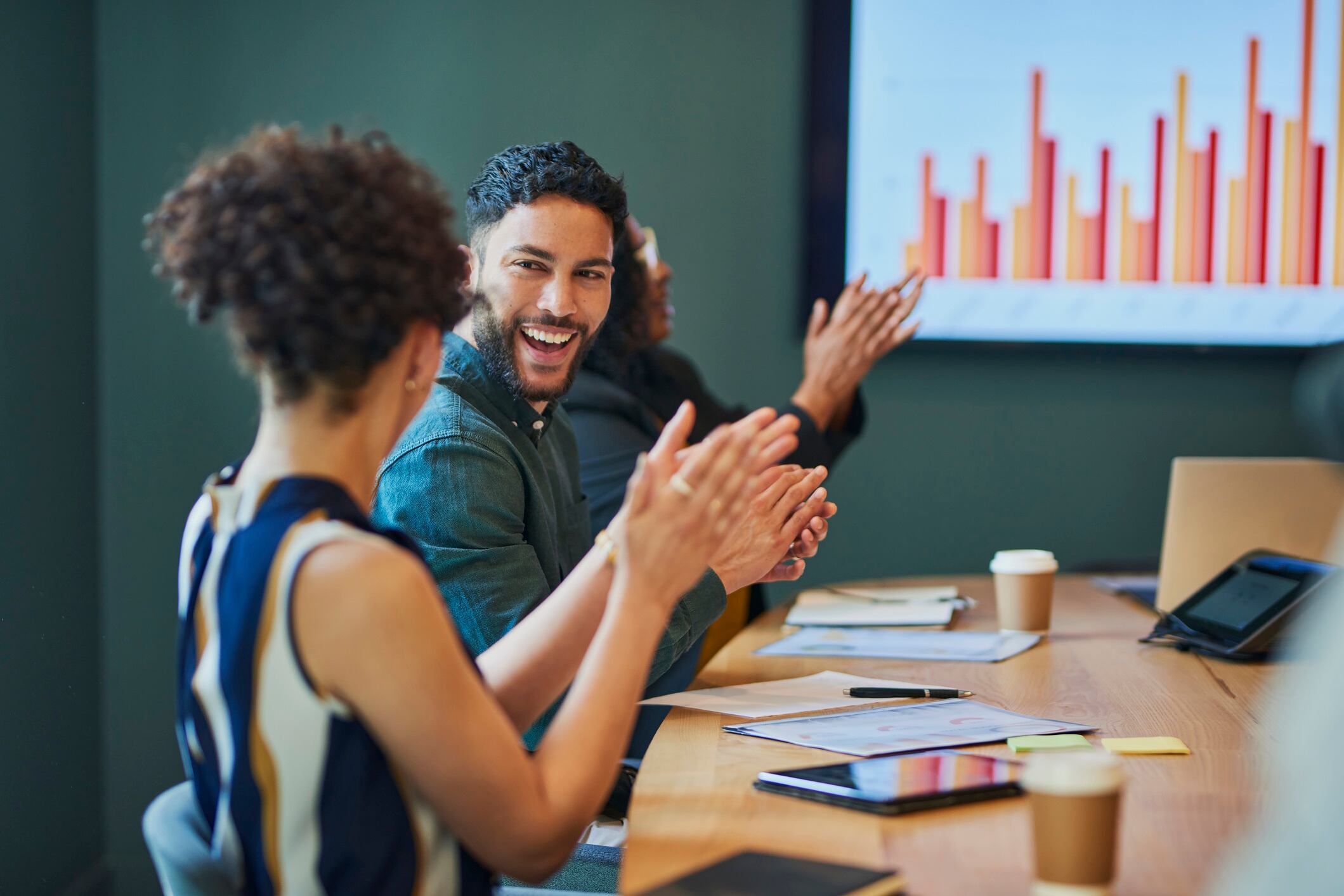 Group of business people clapping in a meeting