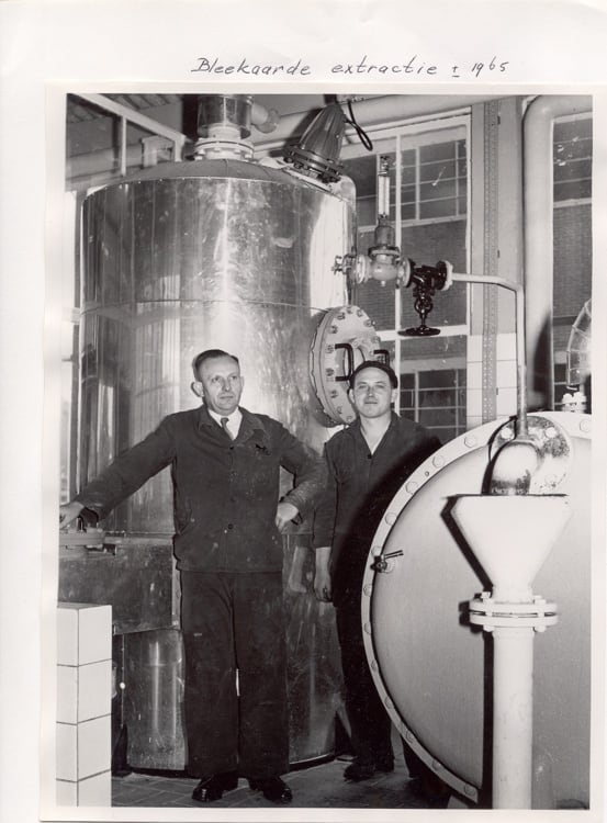 Employees stand beside extraction equipment at a Duyvis facility circa 1965. The company began as an oil mill in 1806 before evolving into one of the Netherlands' best-known nuts and savoury snacks brands.