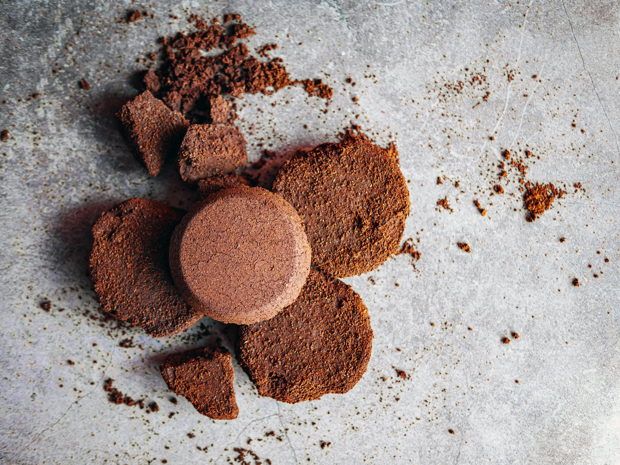 Top view of coffee grounds from espresso machine. coffee ground on gray background