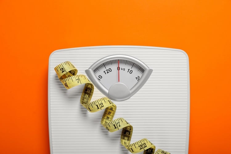 Pair of scales with orange background.