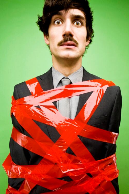 Businessman tied up in red tape