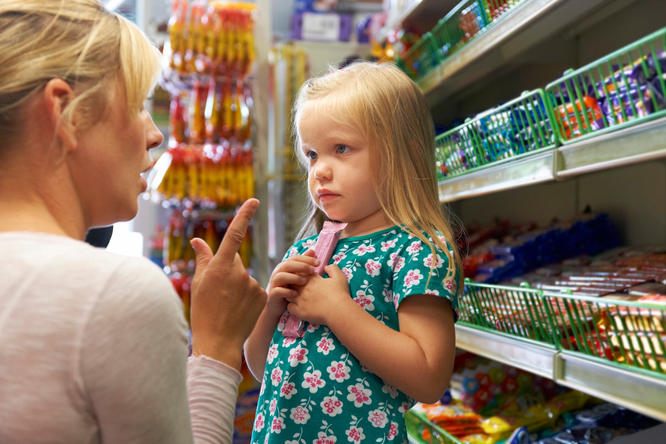 Girl Having Argument With Mother At Candy Counter In Supermarket MachineHeadz GettyImages