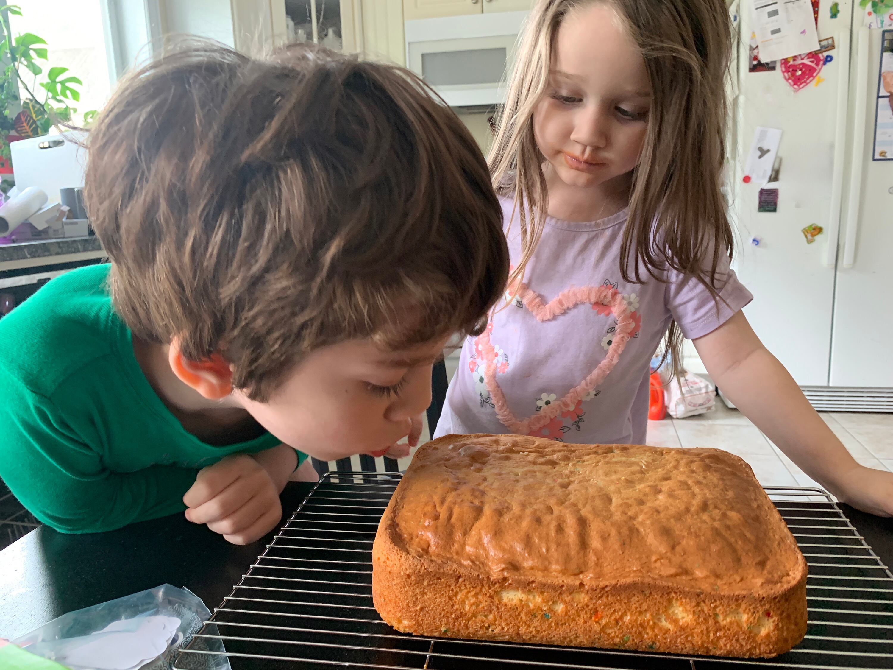 Kids drooling over just baked cake