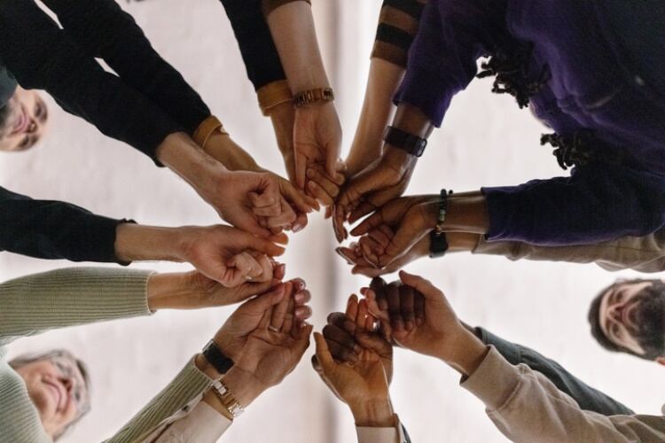 Advocacy group with hands together