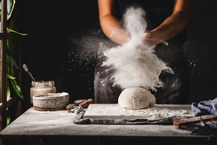 Baker working with flour