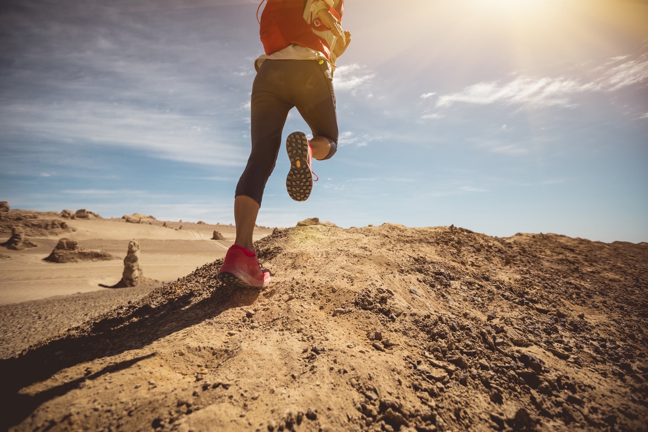 Fitness woman cross country running in the desert Izf GettyImages