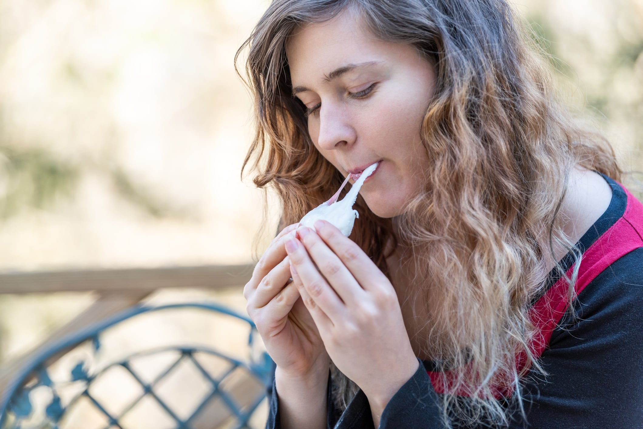 Young woman eating stretchy mochi