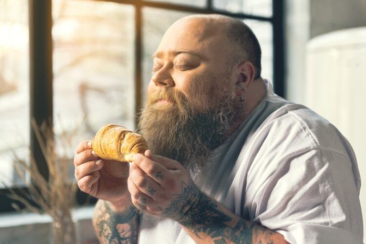 Man smelling a croissant