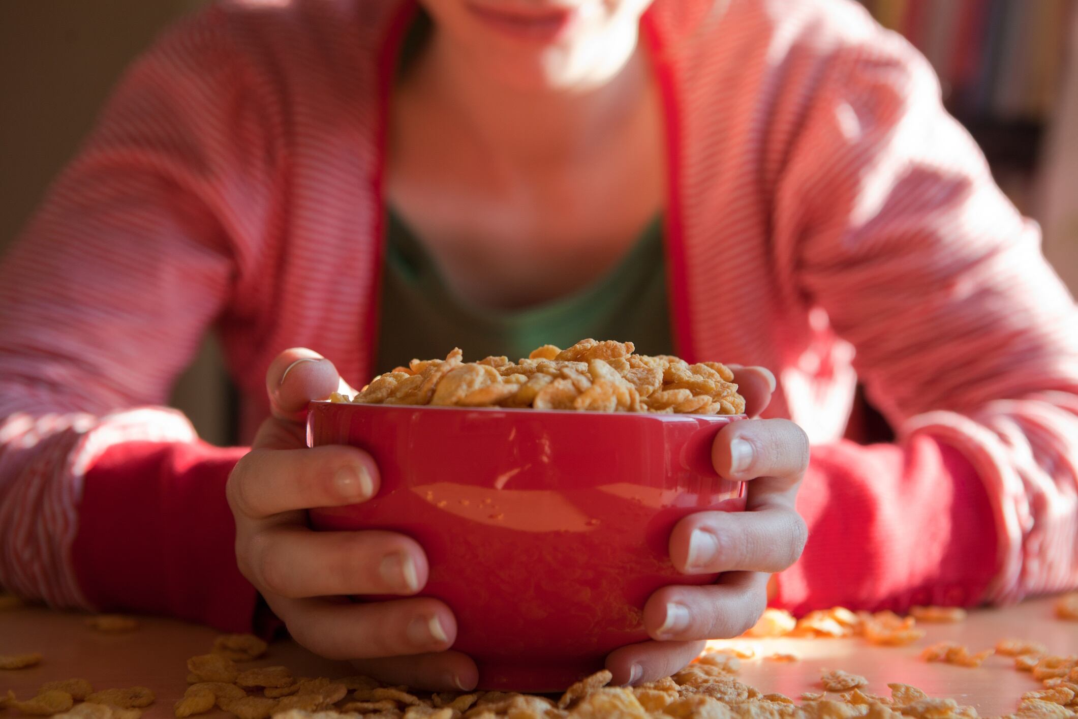 Woman with a bowl of breakfast cereal