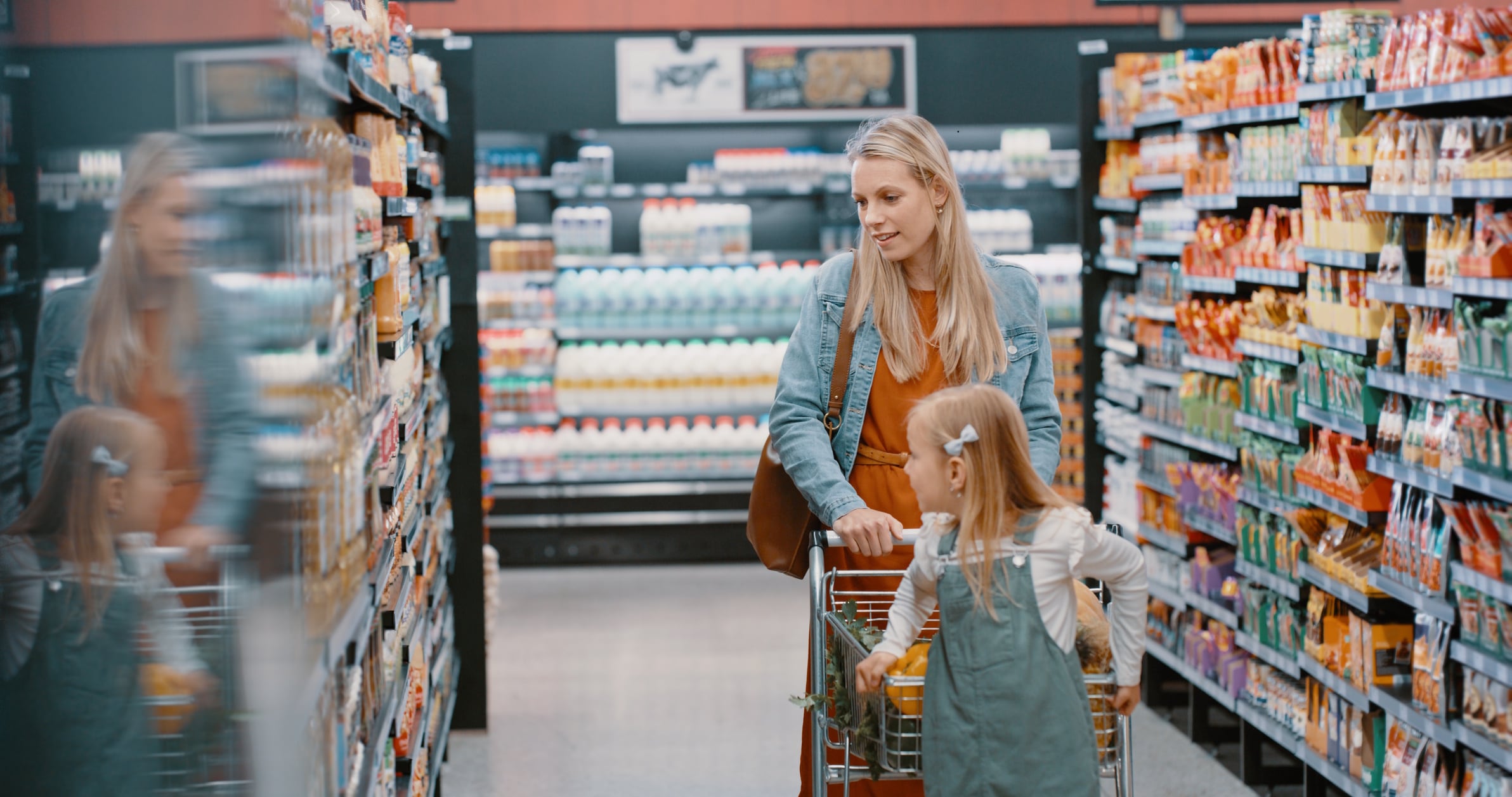 Grocery, shopping and mother with kid at the store, shop or supermarket buying food and using a trolley or cart. Mommy, single parent and customer mom with daughter or child purchase groceries aisle