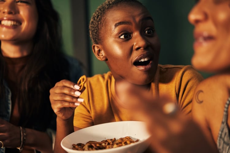 Regional differences also play a significant role in shaping the market - friends sharing snacks