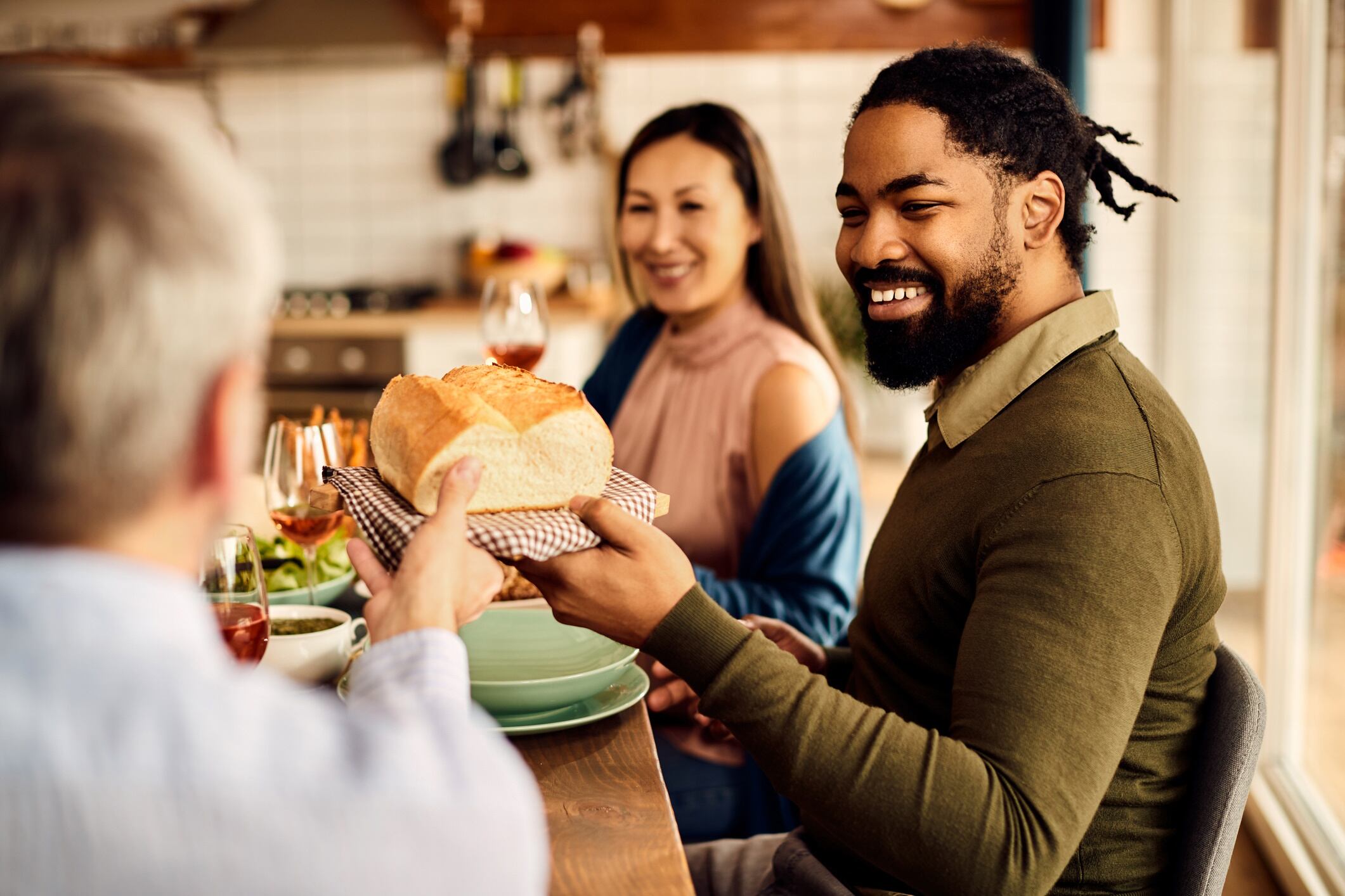 Friends sharing bread at the table