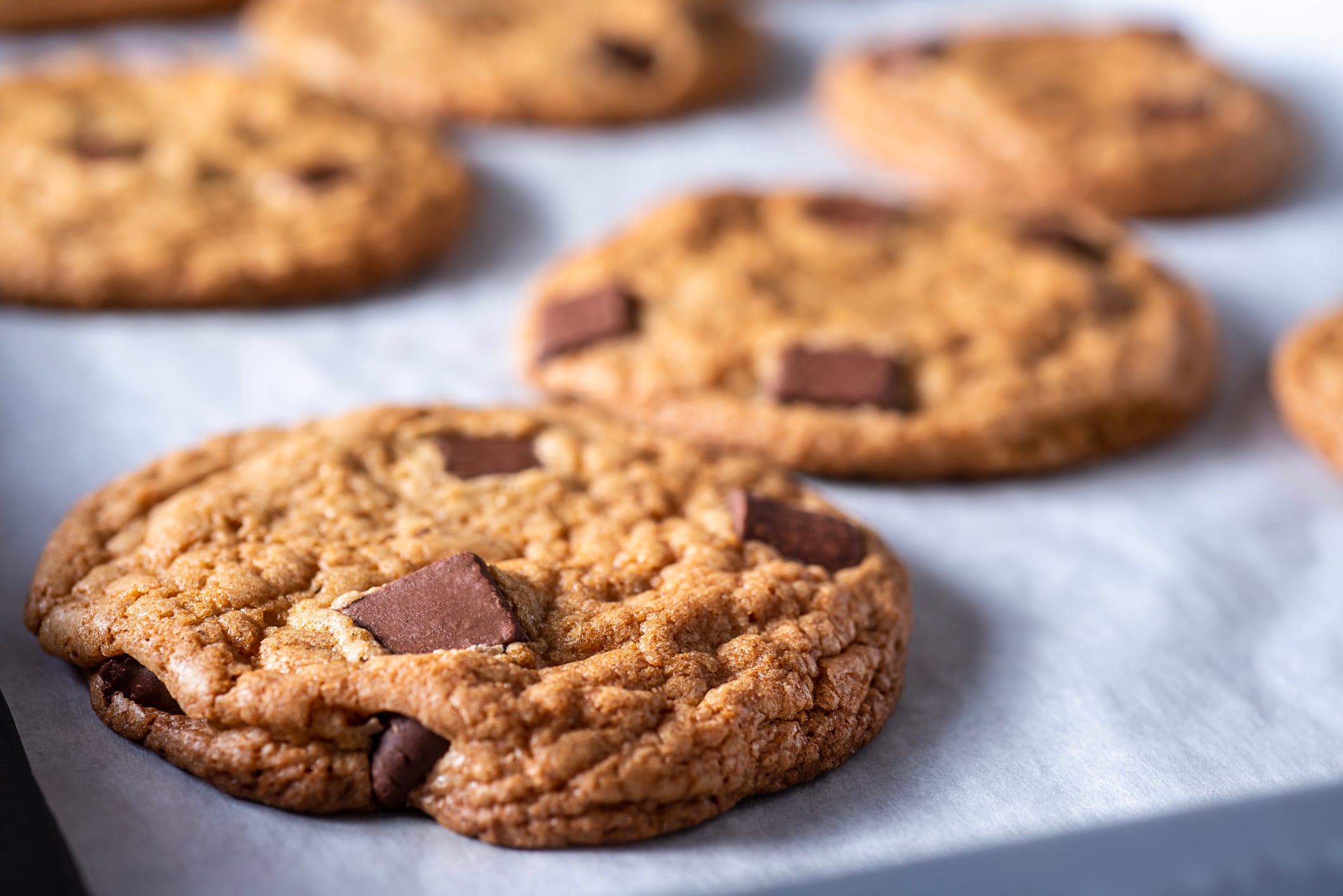 Homemade Chocolate Chunk Cookies on a Parchment-Lined Baking Sheet