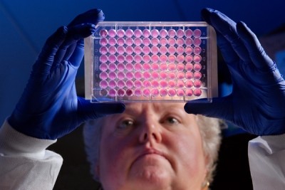 CDC’s Kitty Anderson holds up a 96-well plate used for testing the ability of bacteria to growth in the presence of antibiotics