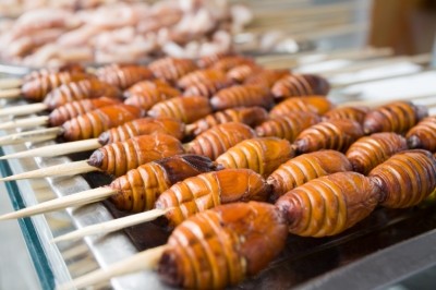 Barbecued skewered silkworms on sale in Asia. Could insects help meet growing demand for protein-rich foods?