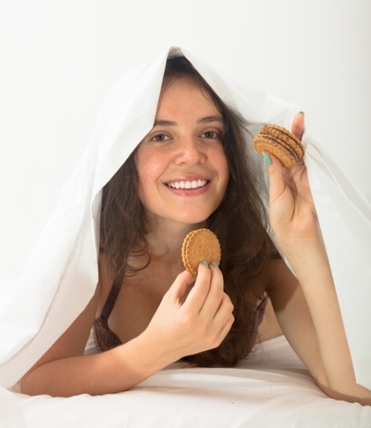 Girl eating cookies in bed Jack F