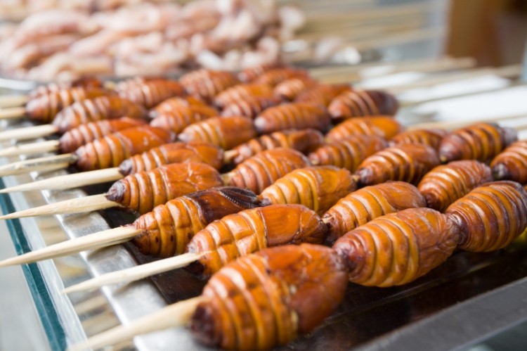 Barbecued skewered silkworms on sale in Asia. Could insects help meet growing demand for protein-rich foods?