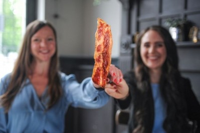 Dr Ruth Faram (left) and Benjamina Bollag (right) unveil bacon prototypes made with 70% cell-based meat (picture: Higher Steaks)